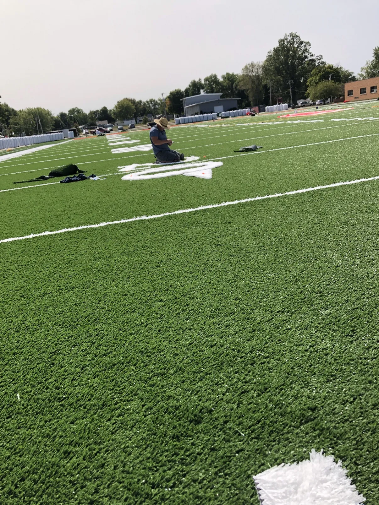 Holben Design crew installing synthetic turf on a sports field