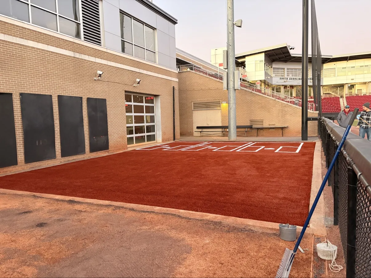 Baseball training area with red turf